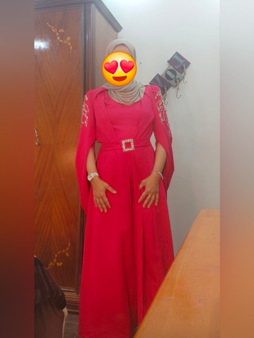 Elegant fuchsia pink jumpsuit with a dramatic cape-style overlay.
